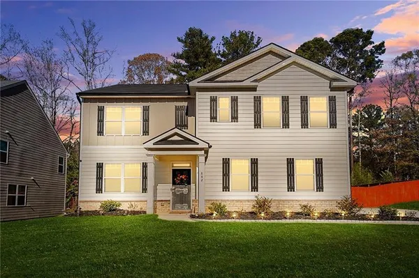 a front view of a house with a yard