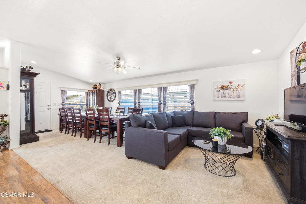 2167 Cardinal Avenue Oxnard, CA 93033 - Photo 11 of 36 a living room with furniture and a dining table with wooden floor