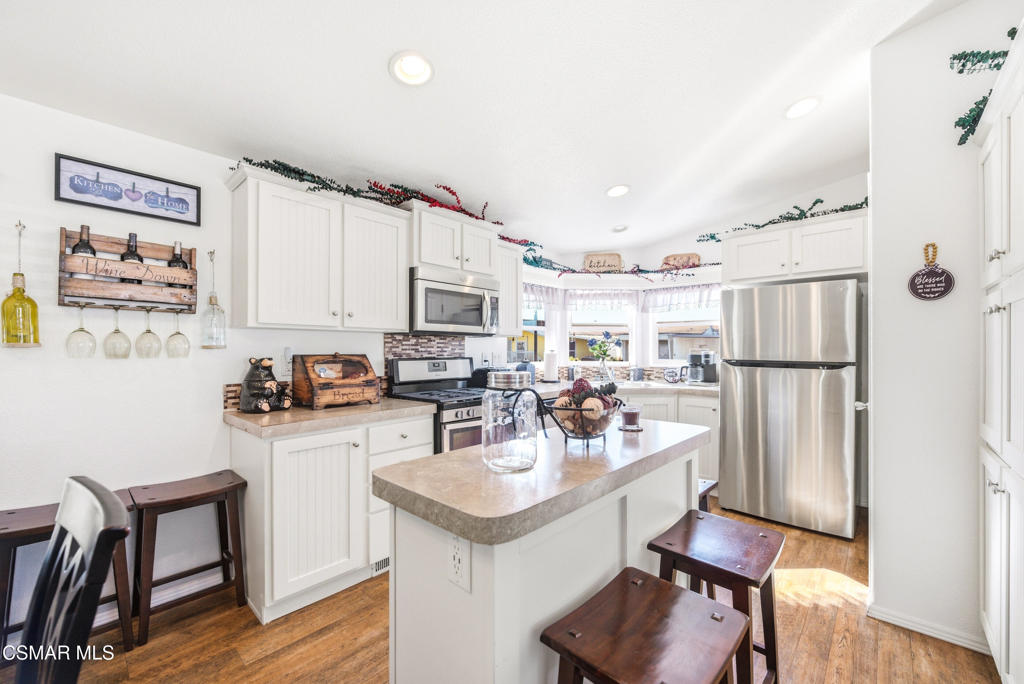 2167 Cardinal Avenue Oxnard, CA 93033 - Photo 17 of 36 a kitchen with a refrigerator and a stove top oven