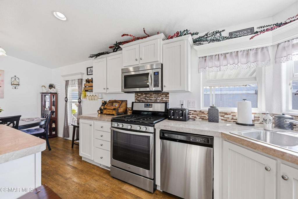 2167 Cardinal Avenue Oxnard, CA 93033 - Photo 20 of 36 a kitchen with stainless steel appliances a stove sink and microwave