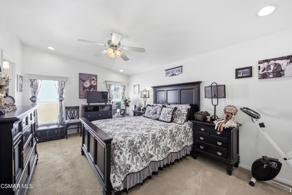 2167 Cardinal Avenue Oxnard, CA 93033 - Photo 24 of 36 a bedroom with a bed and a chandelier