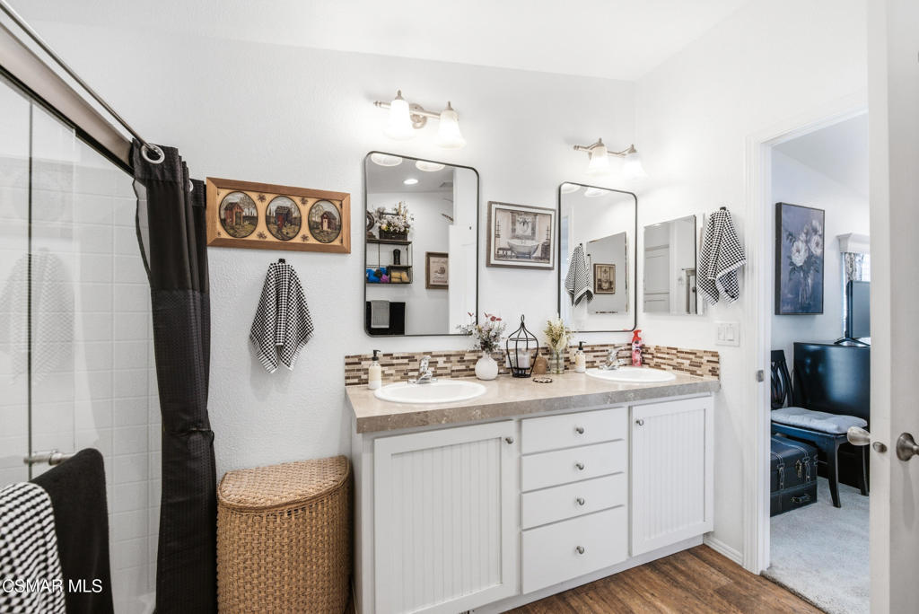 2167 Cardinal Avenue Oxnard, CA 93033 - Photo 27 of 36 a bathroom with a double vanity sink toilet and mirror