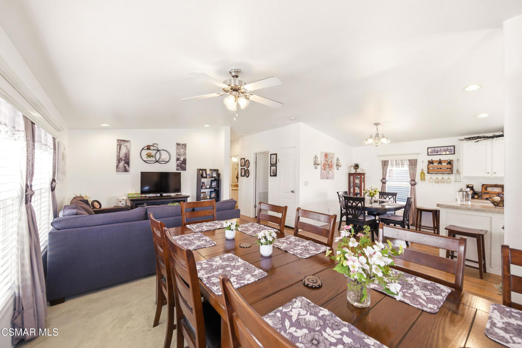 2167 Cardinal Avenue Oxnard, CA 93033 - Photo 6 of 36 a living room with furniture a dining table and a fireplace