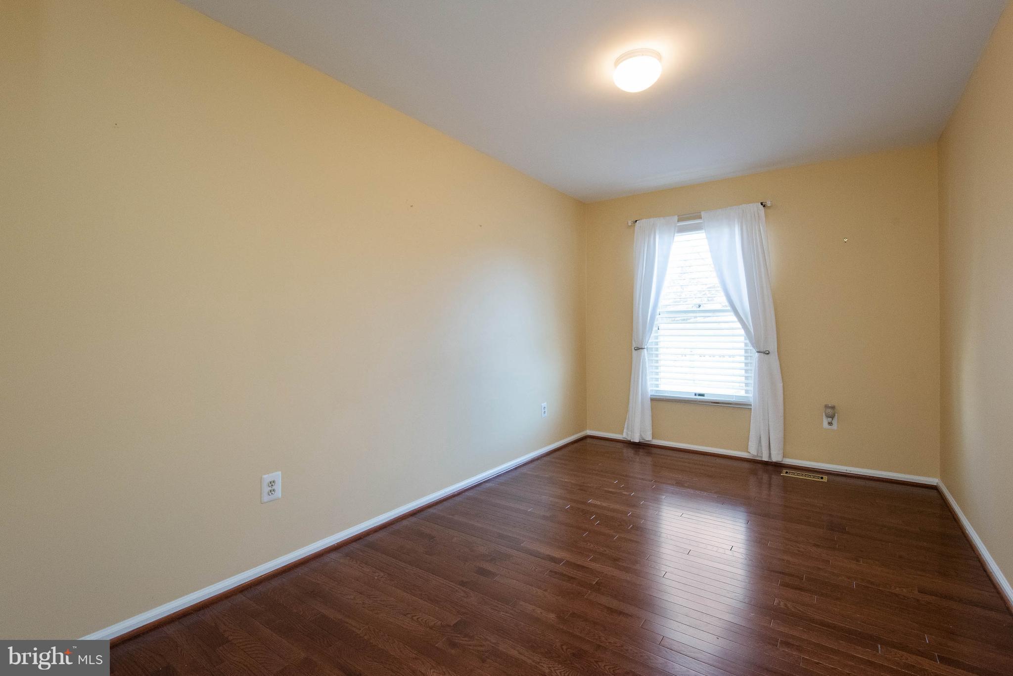 313 Canterfield Road Annapolis, MD 21403 - Photo 29 of 42 an empty room with wooden floor and windows