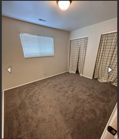 106 East Richelman Lane Wellington, UT 84542 - Photo 7 of 35 Empty room featuring dark carpet and baseboards