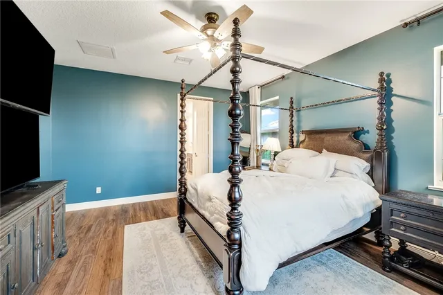 a bed room with a bed and a flat tv screen on a dresser