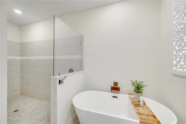 a white bath tub sitting next to a white sink