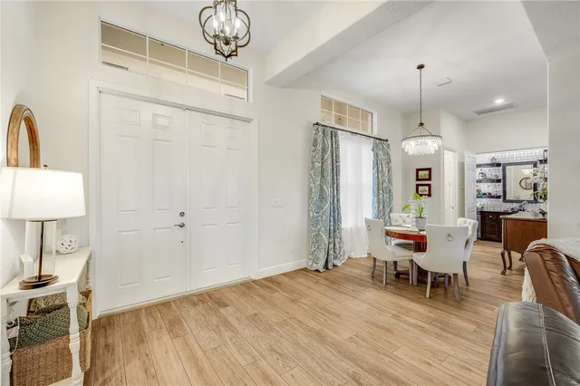 a view of a a dining room with furniture window and wooden floor
