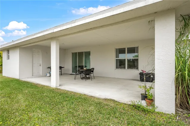 a view of a house with yard and sitting area