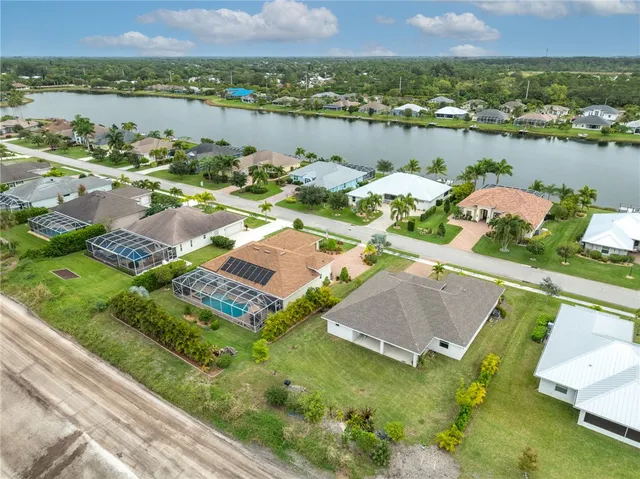 a aerial view of a house with outdoor space and lake view