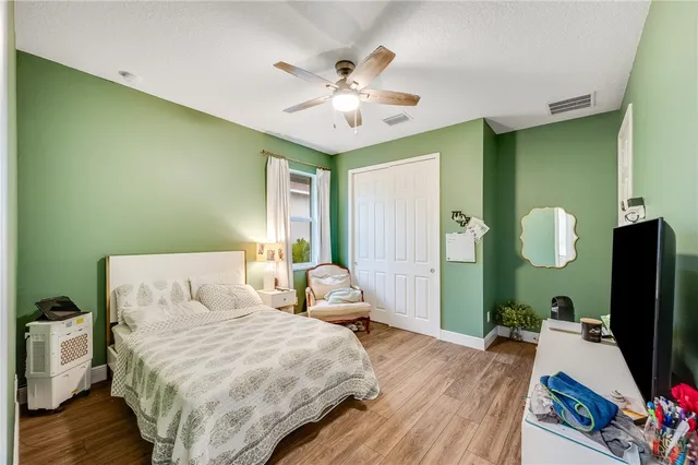 a bedroom with a bed dresser and a flat screen tv