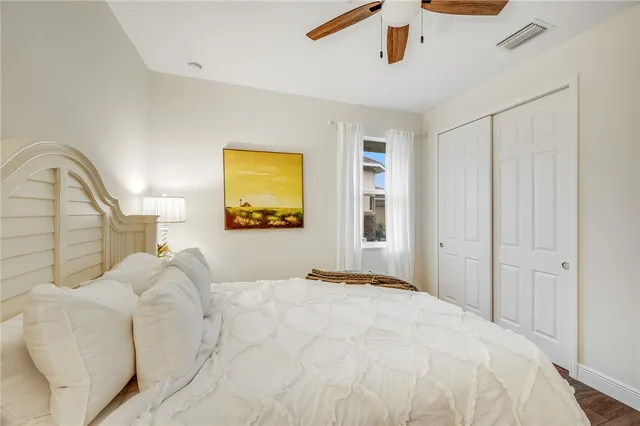 a bedroom with a bed and a painting on the wall