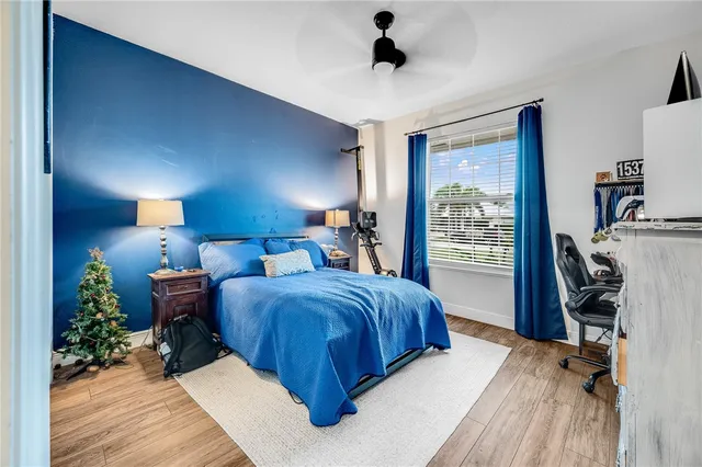 a spacious bedroom with a bed and a window