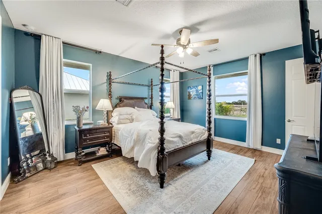 a bedroom with a bed lamp closet and a mirror