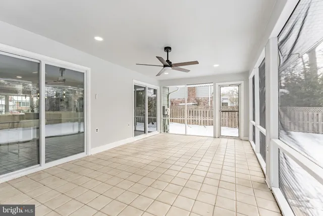a front view of a house with a yard covered in snow