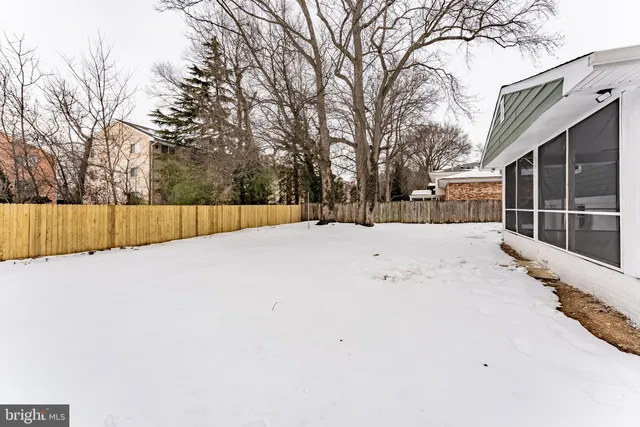 a view of house with a yard covered in snow