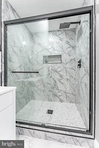 a bathroom with a shower sink and mirror