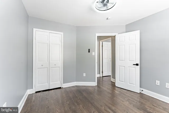 an empty room with windows and closet