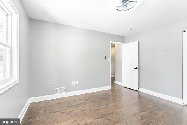 a living room with furniture a fireplace and a window