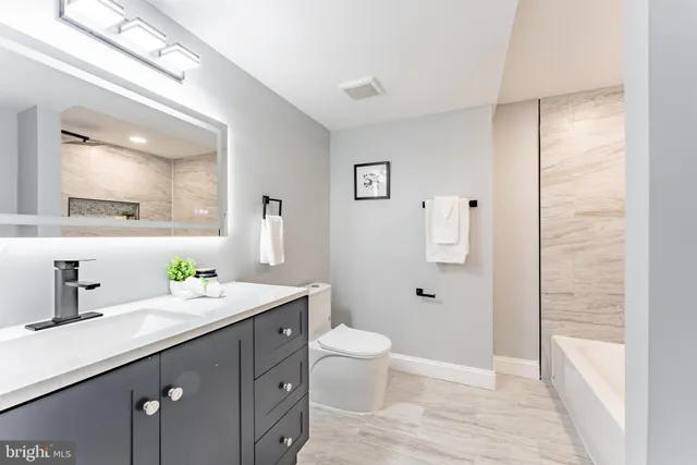 a view of a dining room with furniture and a window