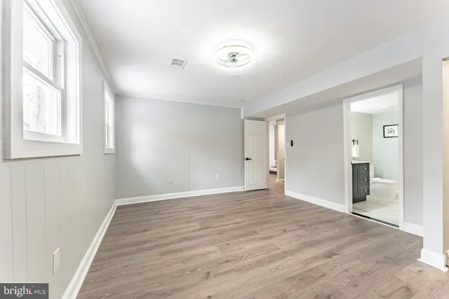 a dining room with furniture and wooden floor