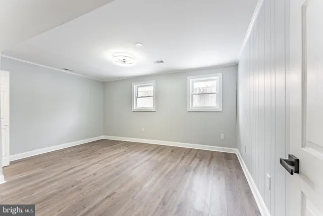 a bathroom with a toilet sink vanity and mirror