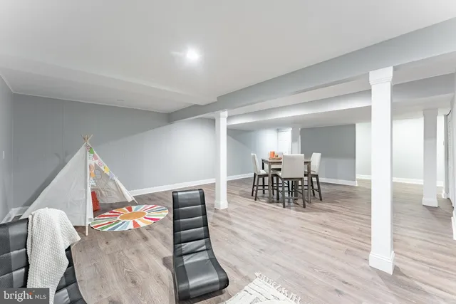 a picture of a hallway with a white wall and a refrigerator