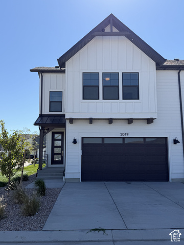 Contemporary exterior with white vertical siding and dark trim