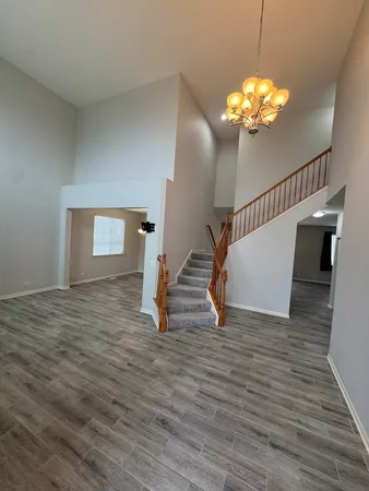 a view of staircase with railing and a window