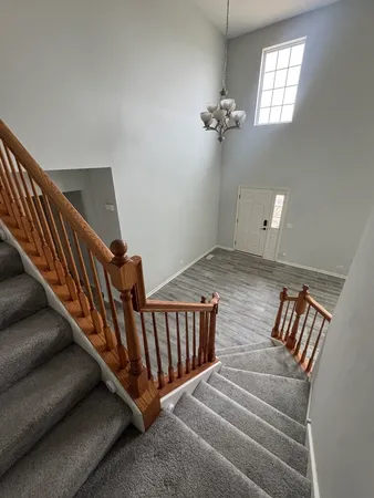 a view of entryway with wooden floor and staircase
