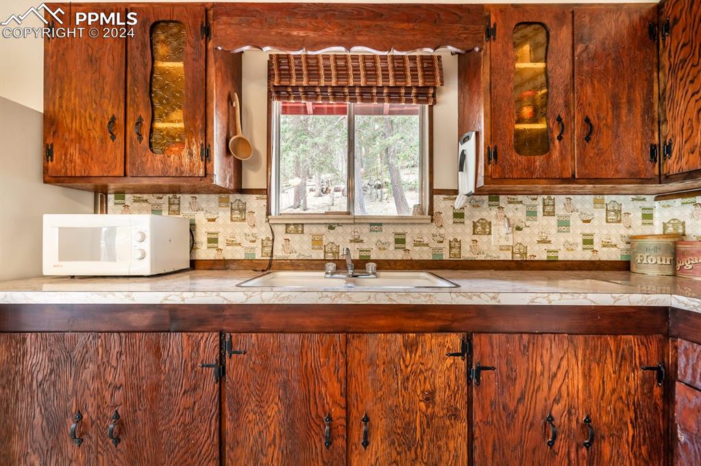 441 Westcliffe Drive Rye, CO 81069 - Photo 13 of 29 a view of a kitchen with a sink a window and cabinets