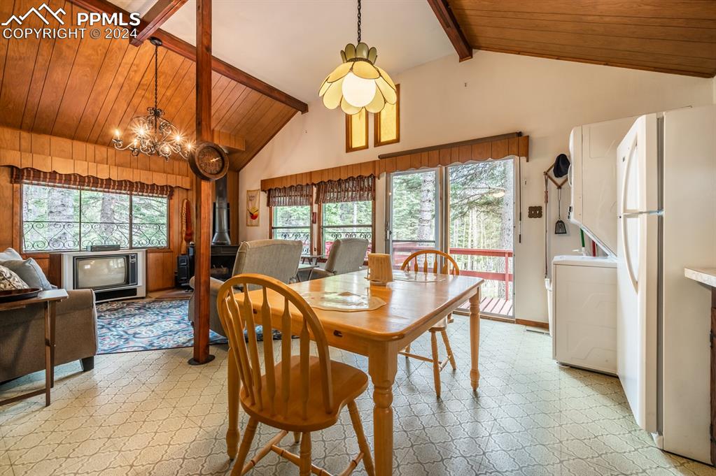 441 Westcliffe Drive Rye, CO 81069 - Photo 14 of 29 a dining room with furniture a chandelier and fireplace