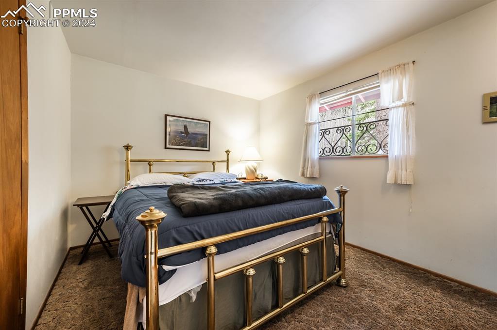 441 Westcliffe Drive Rye, CO 81069 - Photo 15 of 29 a bedroom with a bed and a window