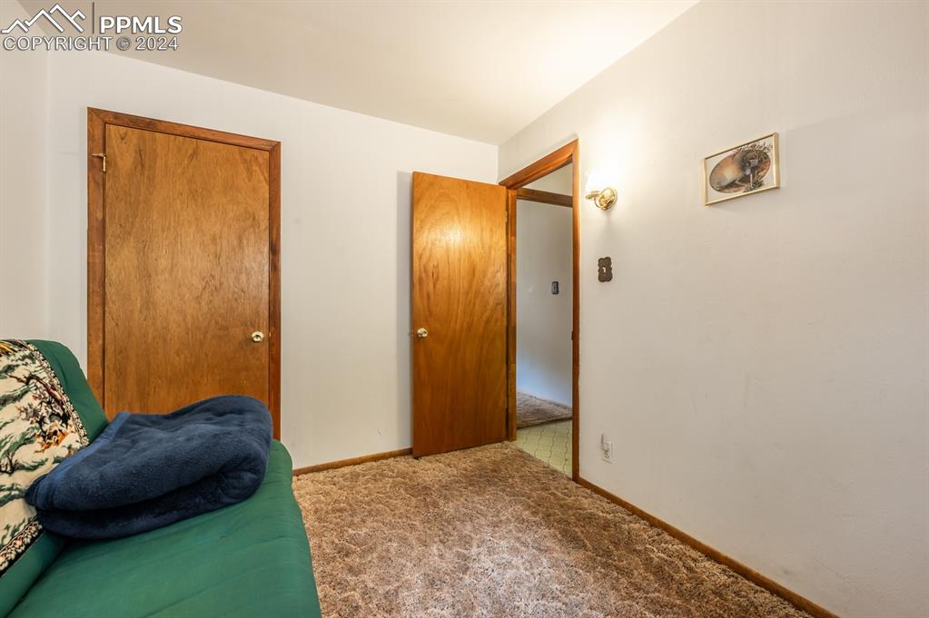 441 Westcliffe Drive Rye, CO 81069 - Photo 20 of 29 a bedroom with a bed and a painting on the wall