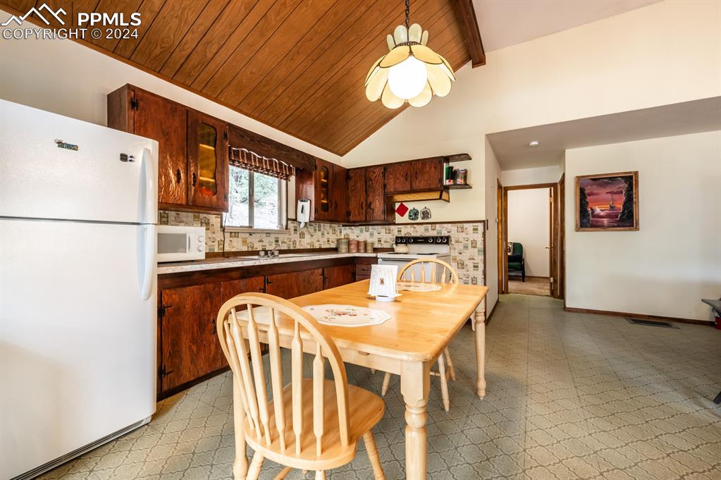 441 Westcliffe Drive Rye, CO 81069 - Photo 10 of 29 a kitchen with stainless steel appliances granite countertop a refrigerator a sink dishwasher a stove with white cabinets and wooden floor