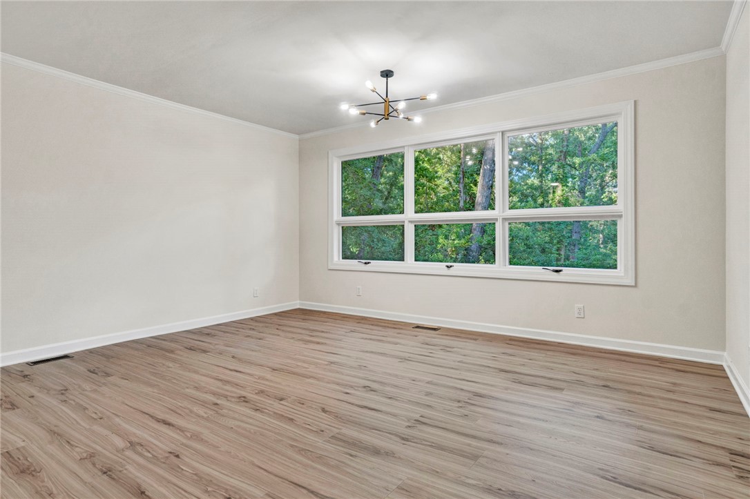 237 Earle Road Central, SC 29630 - Photo 10 of 24 A naturally illuminated living area features light wood flooring and an oversized window framing mature trees.