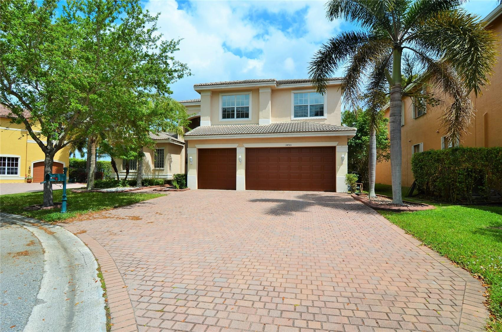 5455 Southwest 191st Terrace Miramar, FL 33029 - Photo 1 of 20 a front view of a house with a yard and garage