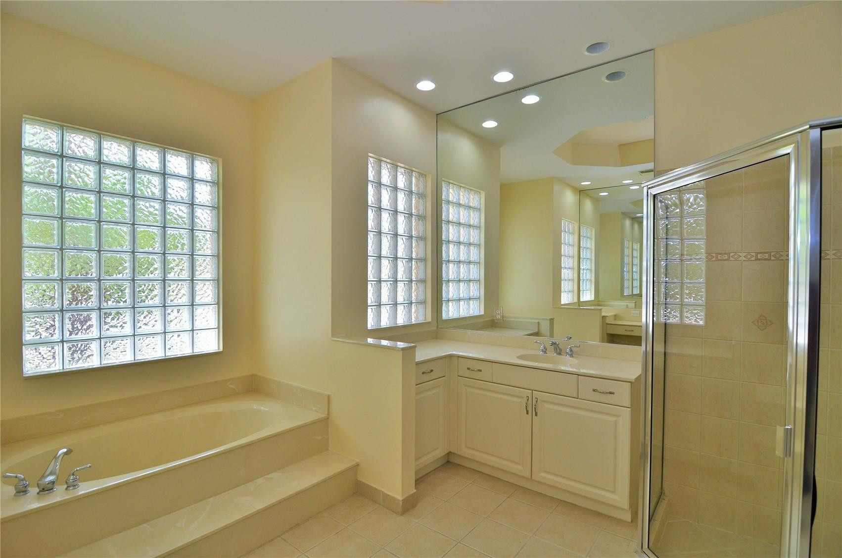 5455 Southwest 191st Terrace Miramar, FL 33029 - Photo 7 of 20 a bathroom with a double vanity sink bathtub and next to a window