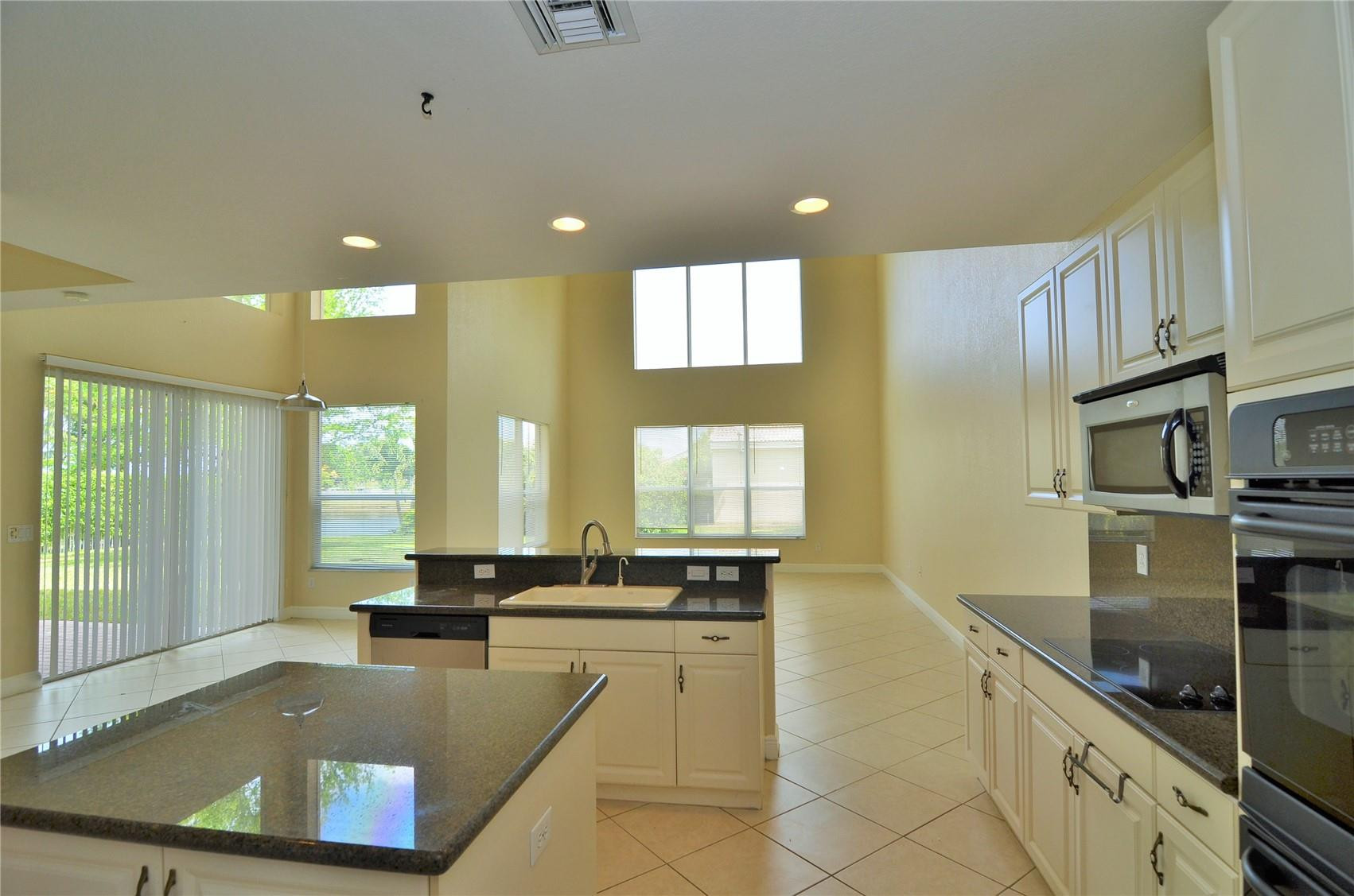 5455 Southwest 191st Terrace Miramar, FL 33029 - Photo 10 of 20 a large kitchen with granite countertop a large counter top stainless steel appliances and windows