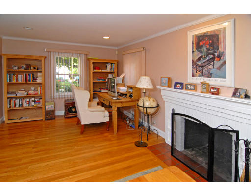 126 Bonad Road Brookline, MA 02467 - Photo 3 of 9 a living room with furniture a fireplace and a bookshelf