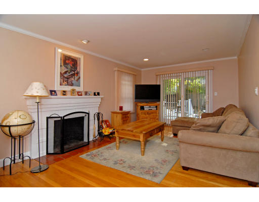 126 Bonad Road Brookline, MA 02467 - Photo 4 of 9 a living room with furniture a fireplace and a flat screen tv