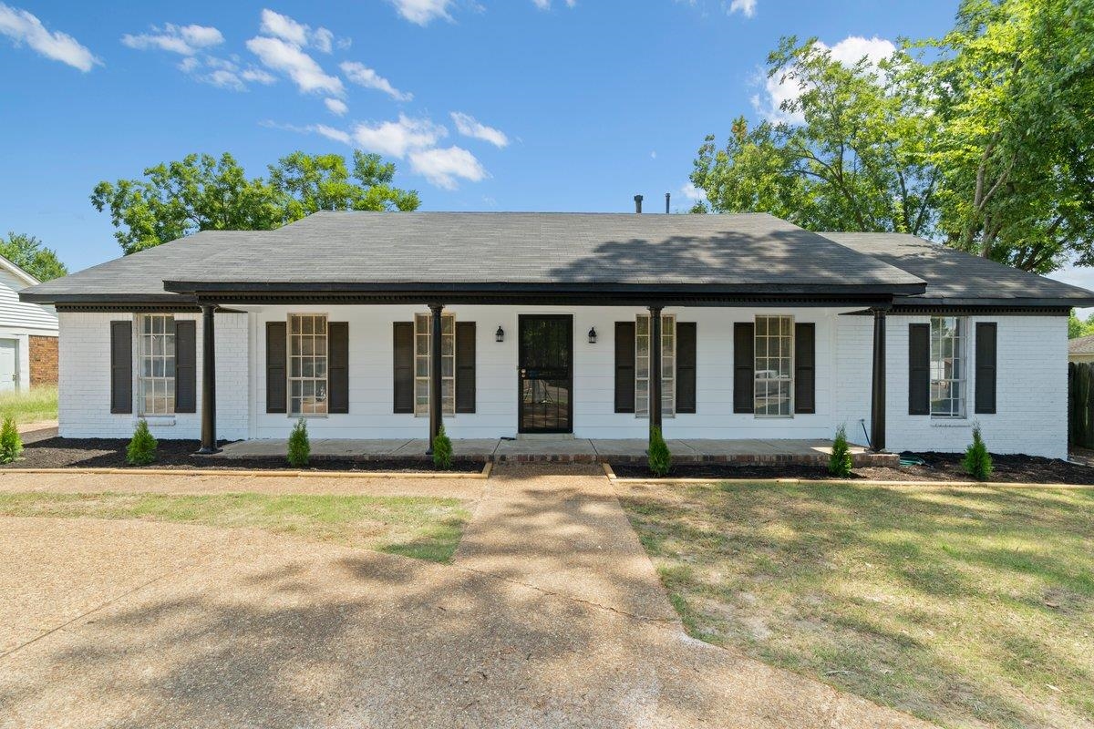 Single story home featuring covered porch