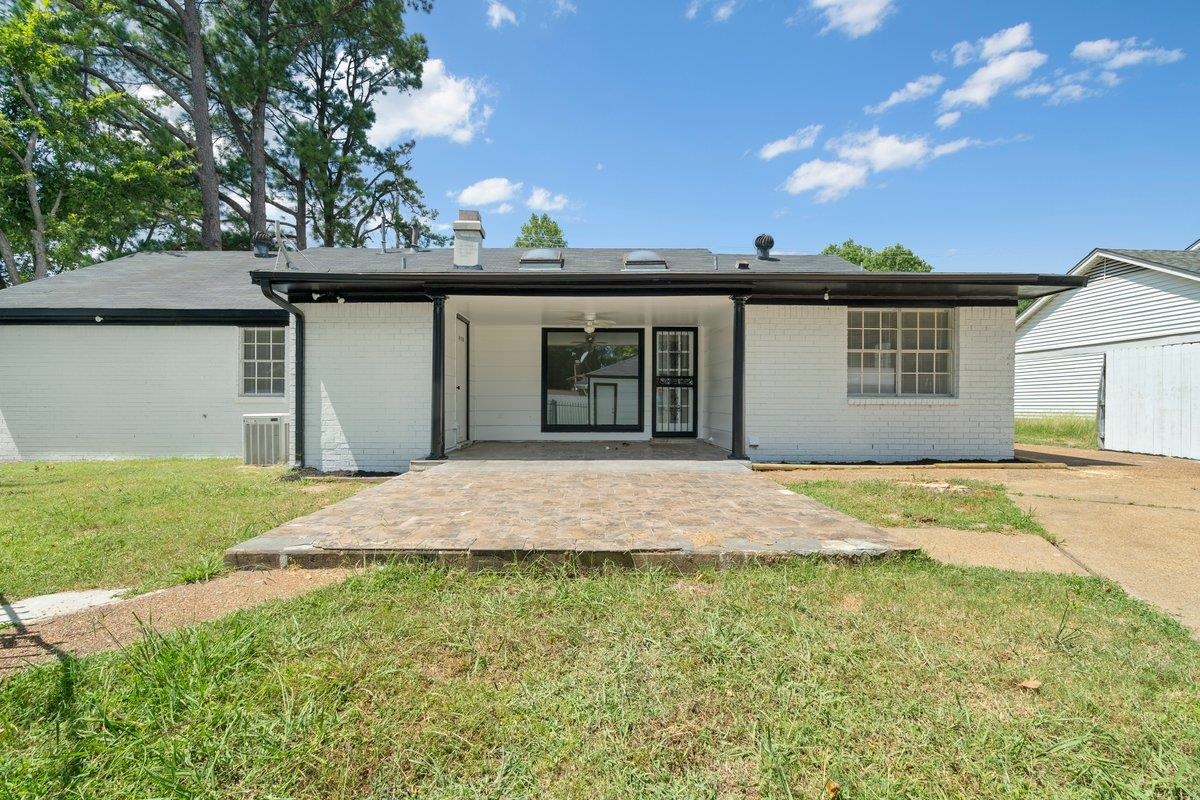 3384 South Mendenhall Road Memphis, TN 38115 - Photo 21 of 22 Back of property featuring a patio, a yard, and central air condition unit