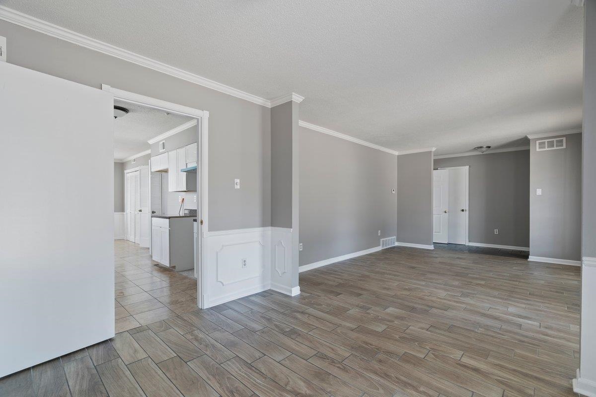 3384 South Mendenhall Road Memphis, TN 38115 - Photo 8 of 22 Unfurnished room featuring a textured ceiling, crown molding, and light tile patterned floors