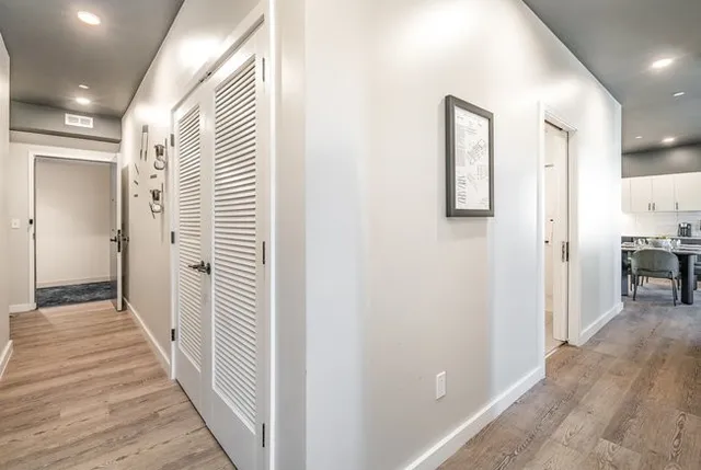a bedroom with a bed and painting on the wall