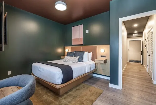 a bedroom with a bed and wall painting