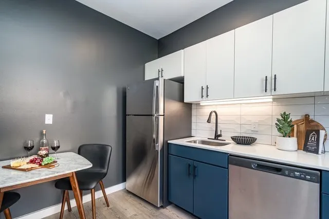 a kitchen with stainless steel appliances a stove and a microwave