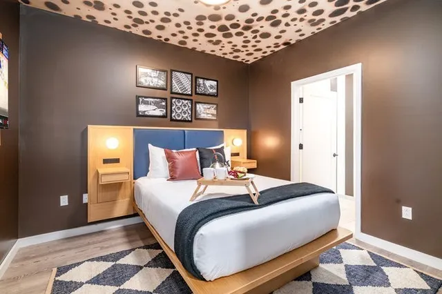 a large kitchen with stainless steel appliances kitchen island granite countertop a refrigerator and a sink