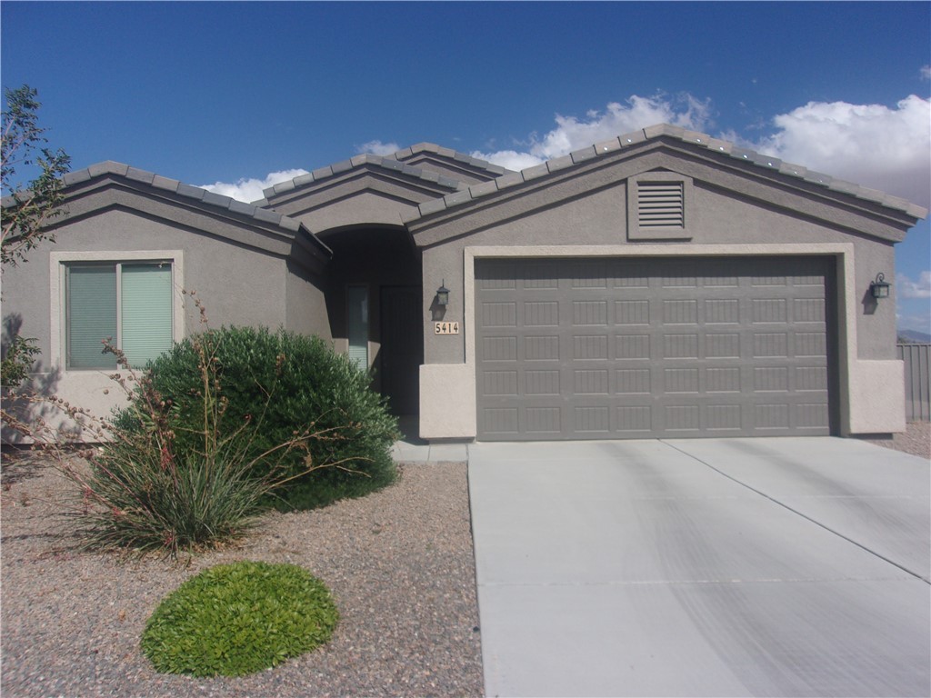 5414 Eagle View Road Kingman, AZ 86409 - Photo 1 of 39 Ranch-style home featuring a garage, stucco siding, a tiled roof, and concrete driveway