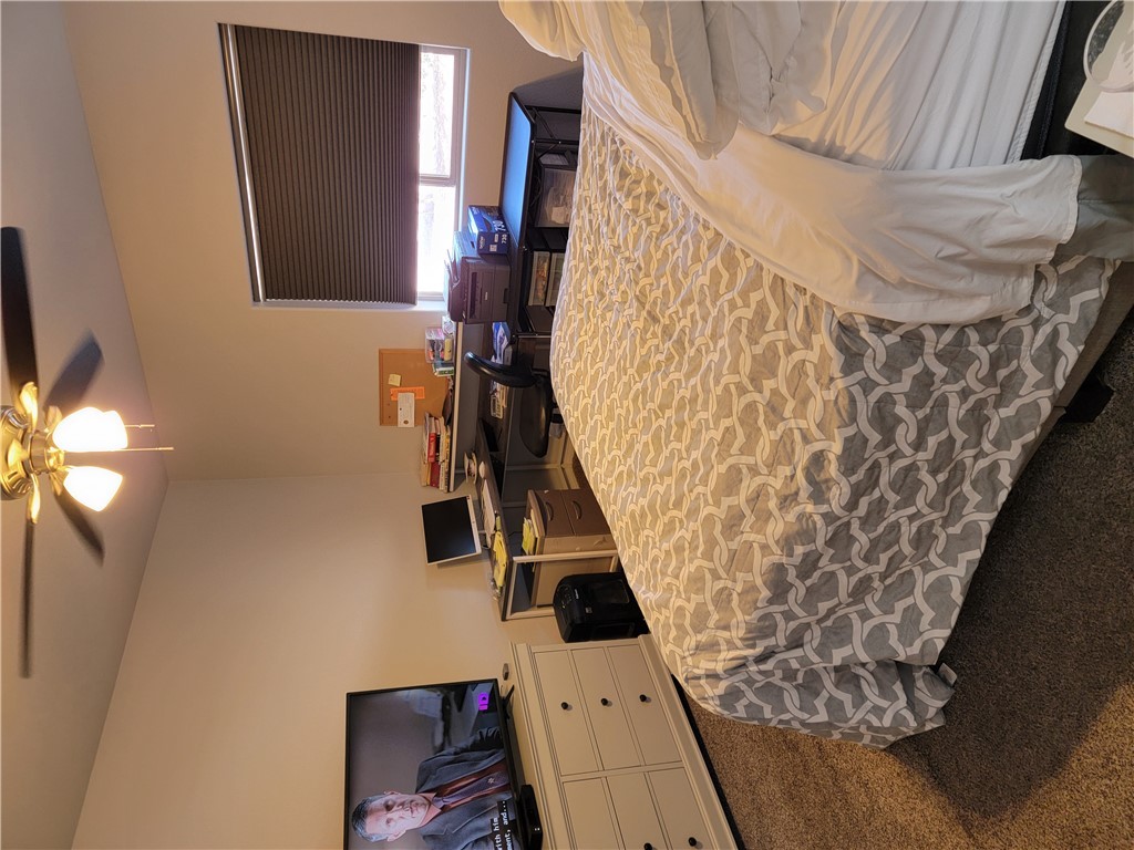 5414 Eagle View Road Kingman, AZ 86409 - Photo 27 of 39 Carpeted bedroom with a ceiling fan